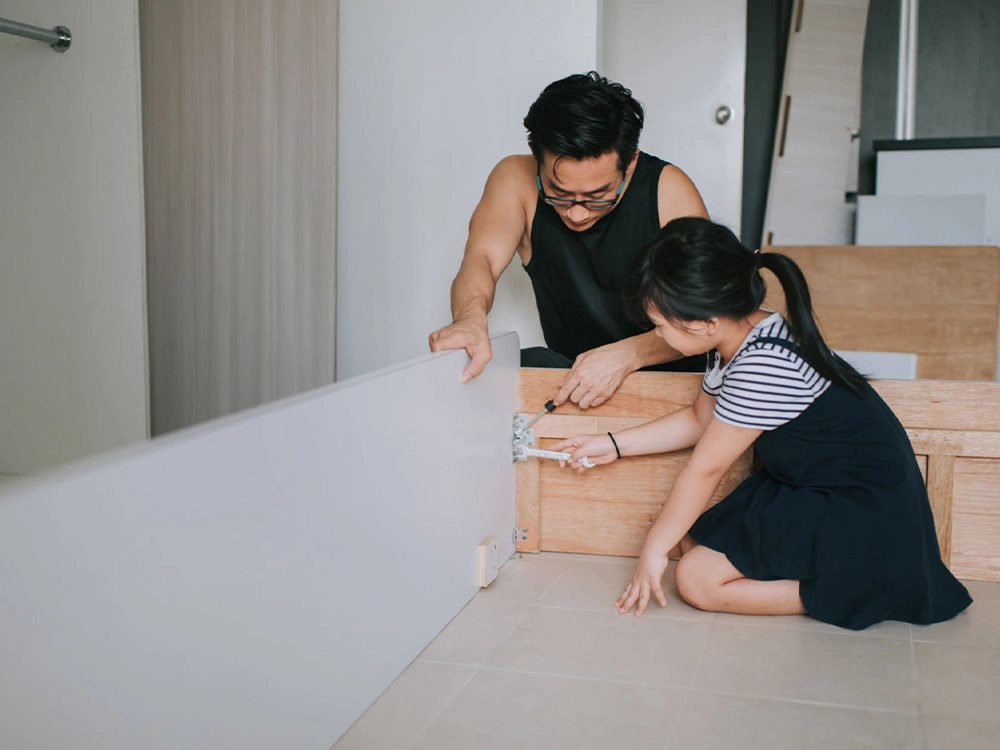 father and daughter assemble bed